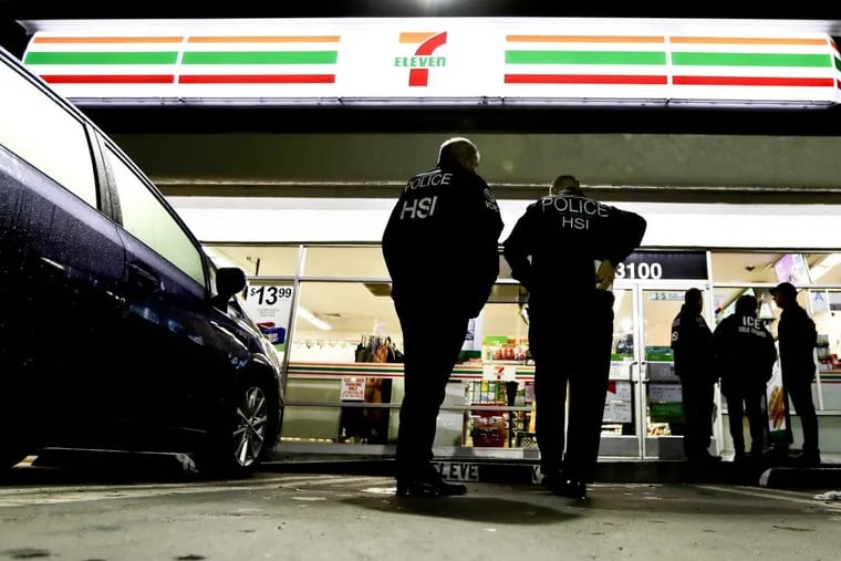 U.S. Immigration and Customs Enforcement agents serve an employment audit notice at a 7-Eleven convenience store Wednesday, Jan. 10, 2018, in Los Angeles. Agents said they targeted about 100 7-Eleven stores nationwide Wednesday to open employment audits and interview workers.