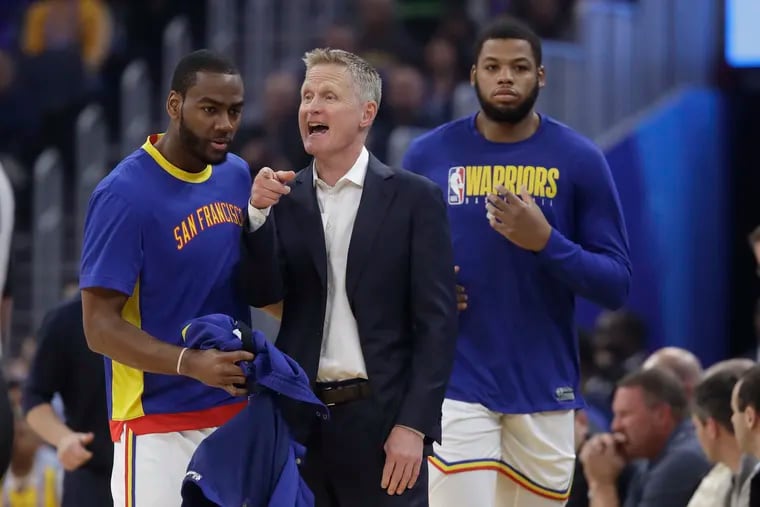 Golden State Warriors coach Steve Kerr with Alec Burks (left) and Omari Spellman during a game against the Trail Blazers.