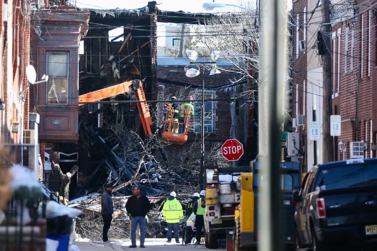 Damage is visible at the scene where an explosion and fire Thursday left several homes destroyed on the 1400 block of South 8th St. in Philadelphia on Friday, Dec. 20, 2019. Two people were killed following the blast.
