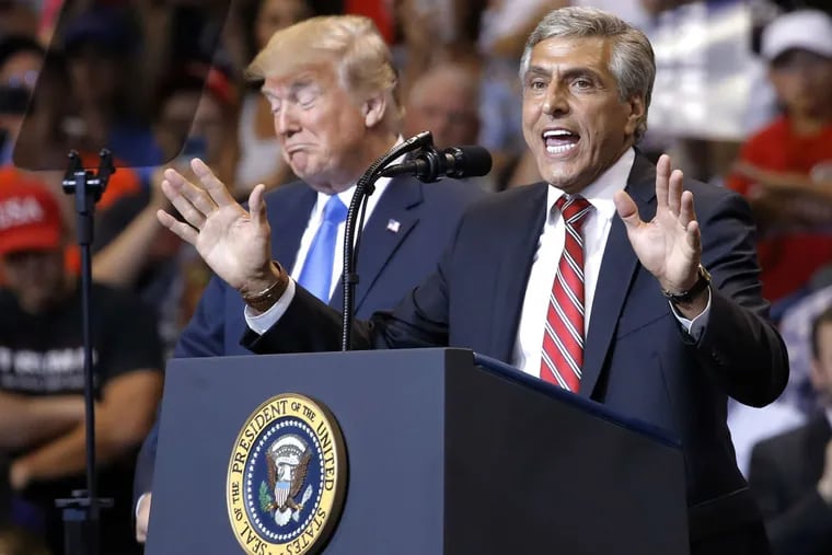 President Donald Trump listens to Senate candidate Rep. Lou Barletta, R-Pa., speaks during a rally, Thursday, Aug. 2, 2018, at Mohegan Sun Arena at Casey Plaza in Wilkes Barre, Pa.