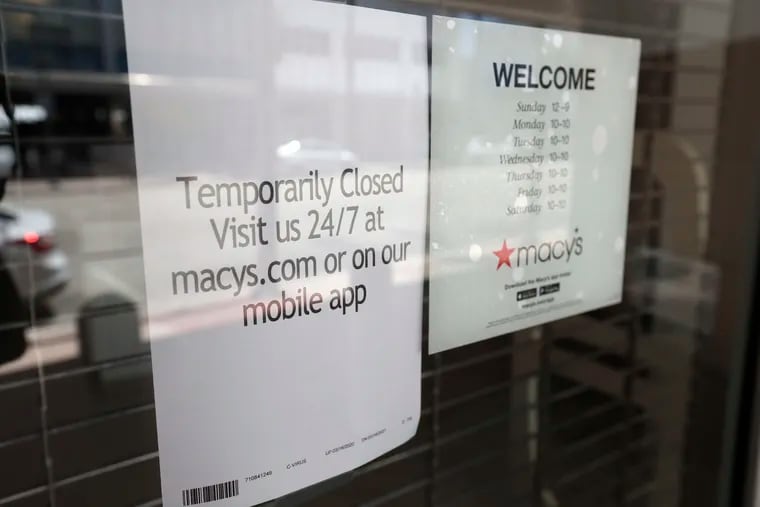 A sign at a closed Macy’s, which is furloughing thousands of employees.