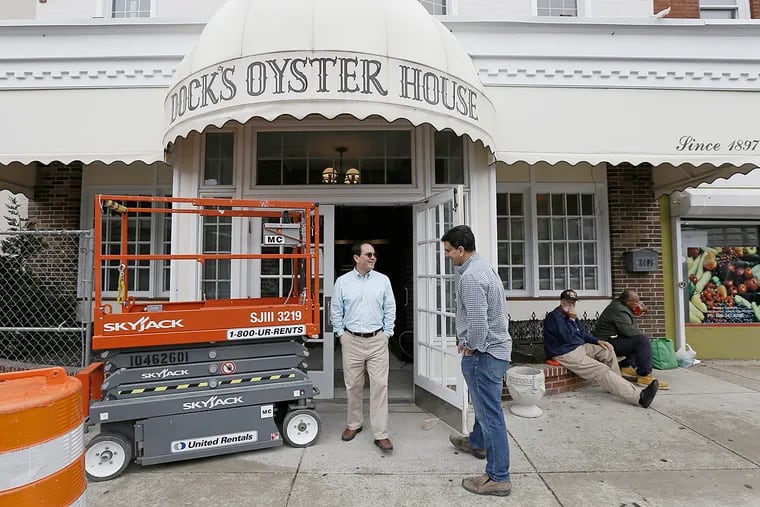 With renovations and expansion continuing in background, restaurant owners Joe Dougherty, left, and Frank Dougherty walk back inside the Dock's Oyster House in Atlantic City