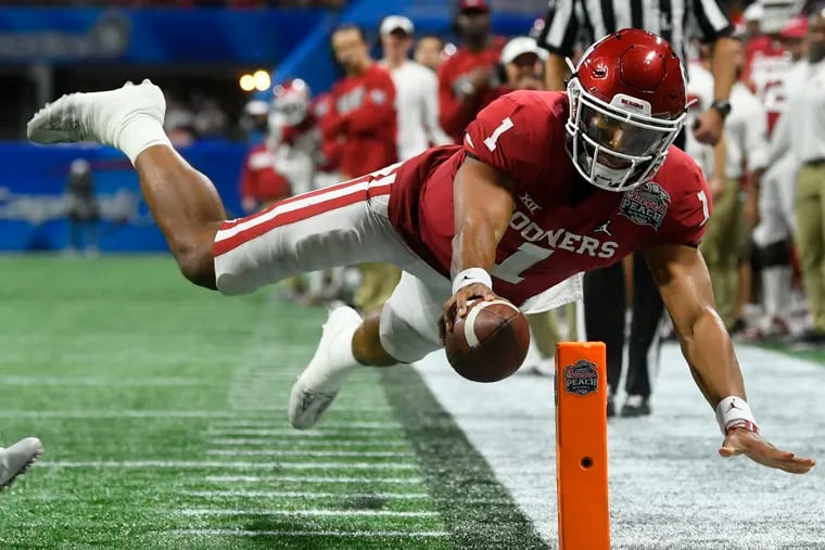 The Eagles hope Jalen Hurts, shown scoring a touchdown for Oklahoma against LSU in the playoffs last year, can develop into a reliable backup for Wentz.