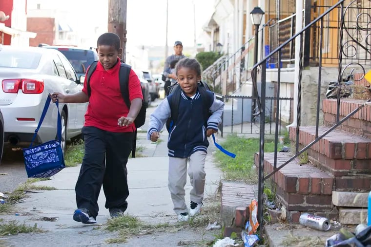 Jalen Absolum, 9, walks home from school in Philadelphia with his younger cousin, Kymani Phillips (right), who is 4 1/2 years old. Despite their age difference, the two boys enjoy being together. Like nearly 2,700 children tested in Philadelphia last year, Jalen has harmful levels of lead in his blood. Lead poisoning can cause irreversible damage and lifelong learning and behavioral problems.