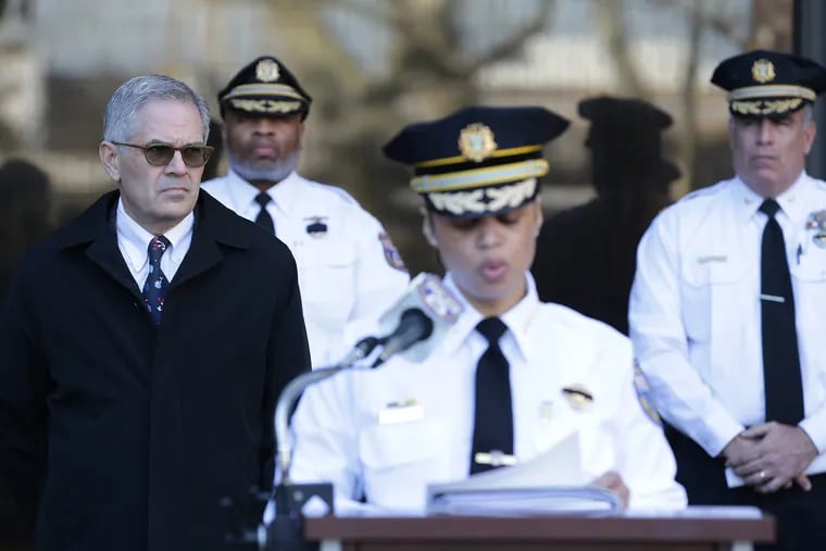 District Attorney Larry Krasner, left, listens as Philadelphia police commissioner Danielle Outlaw addresses the media outside the Police Administration Building during a news conference in March.