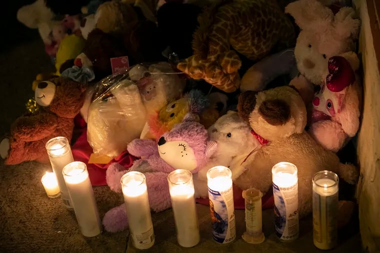 A  memorial for the victims of the fatal fire by 23rd and Parrish is photographed in the Fairmount section of Philadelphia, on Thursday, Jan. 6, 2022. The fire killed 12 people, including eight children, early Wednesday morning.