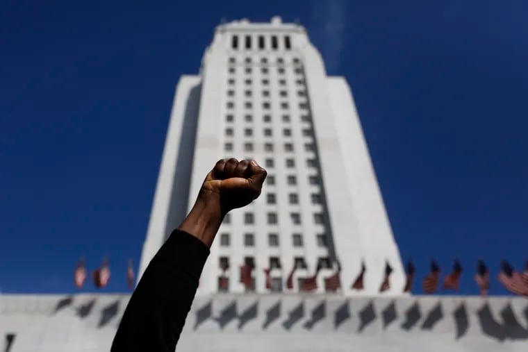 A protester holds up his fist while chanting a slogan during a protest over the death of George Floyd, Friday, May 29, 2020, in Los Angeles. Floyd died in police custody Monday in Minneapolis.