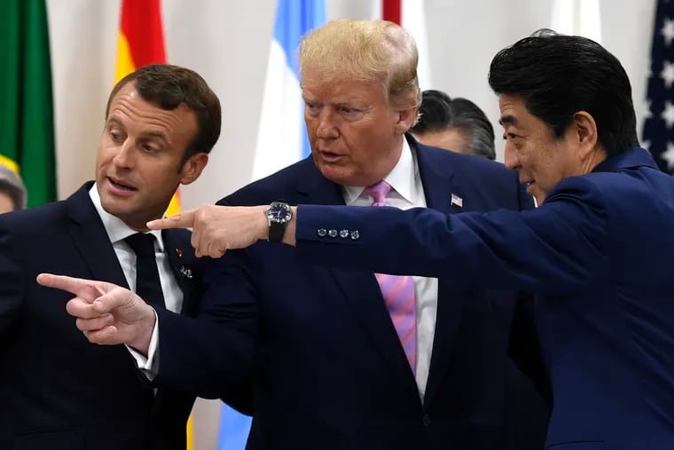French President Emmanuel Macron, President Donald Trump as Japanese Prime Minister Shinzo Abe speak before a working session at the G-20 summit in Osaka, Japan, Friday, June 28, 2019.