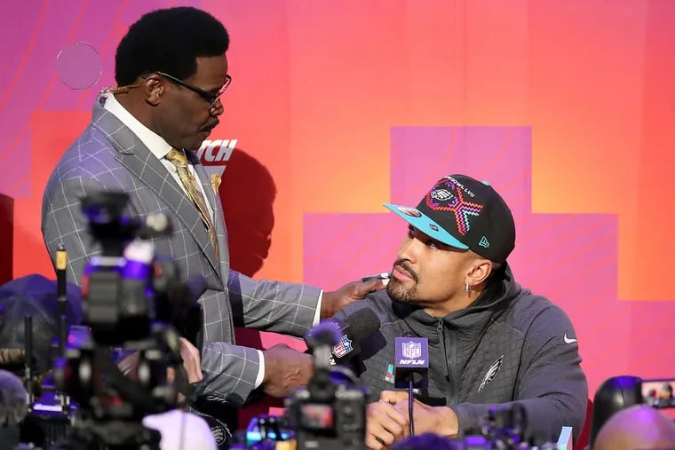 Hall of Famer Michael Irvin (left) interviews Eagles quarterback Jalen Hurts during opening night at the Super Bowl Monday.