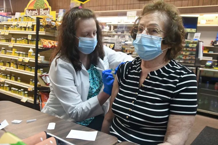 Pharmacist Karen Flynn gives a second Moderna booster shot to her mother, Joann Pangonis, at Morris Drug in Mahanoy City, Pa.