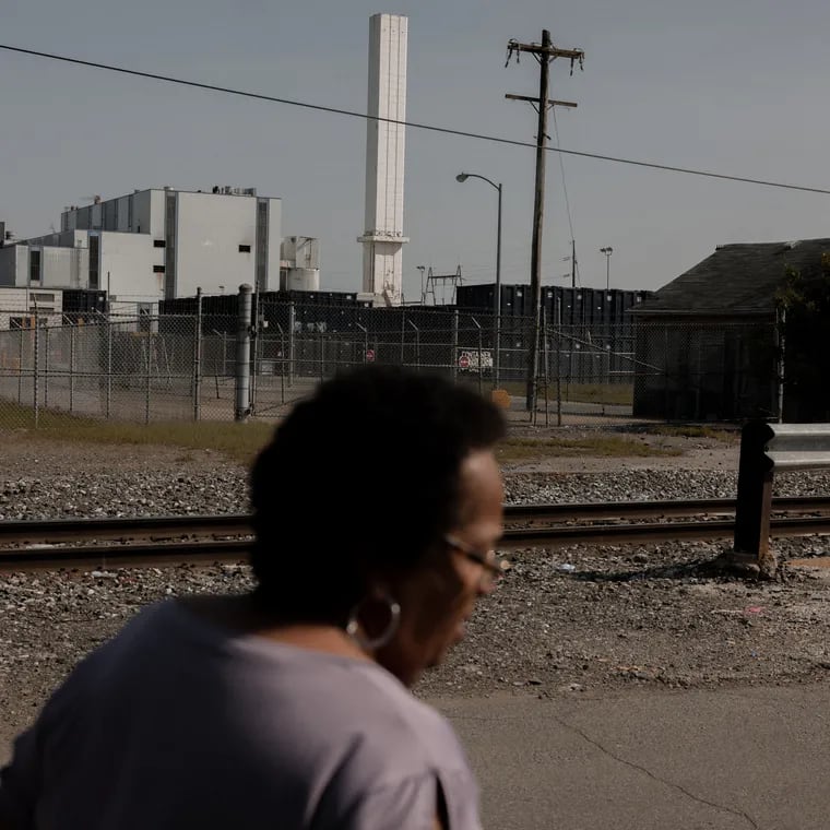 Zulene Mayfield walks on a residential street near the Covanta incineration facility in Chester.