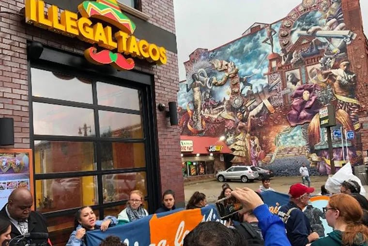 Demonstrators mass outside the Illegal Tacos restaurant on South Broad Street on Tuesday. Stu Bykofsky / Staff