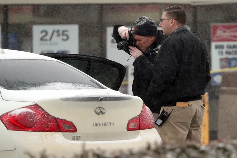 Investigators take photos of a vehicle outside a convenience store in Garnerville, N.Y., Wednesday, Feb. 20, 2019, after the vehicle reportedly struck and injured several people, five of them children. (Peter Carr / The journal News via AP)
