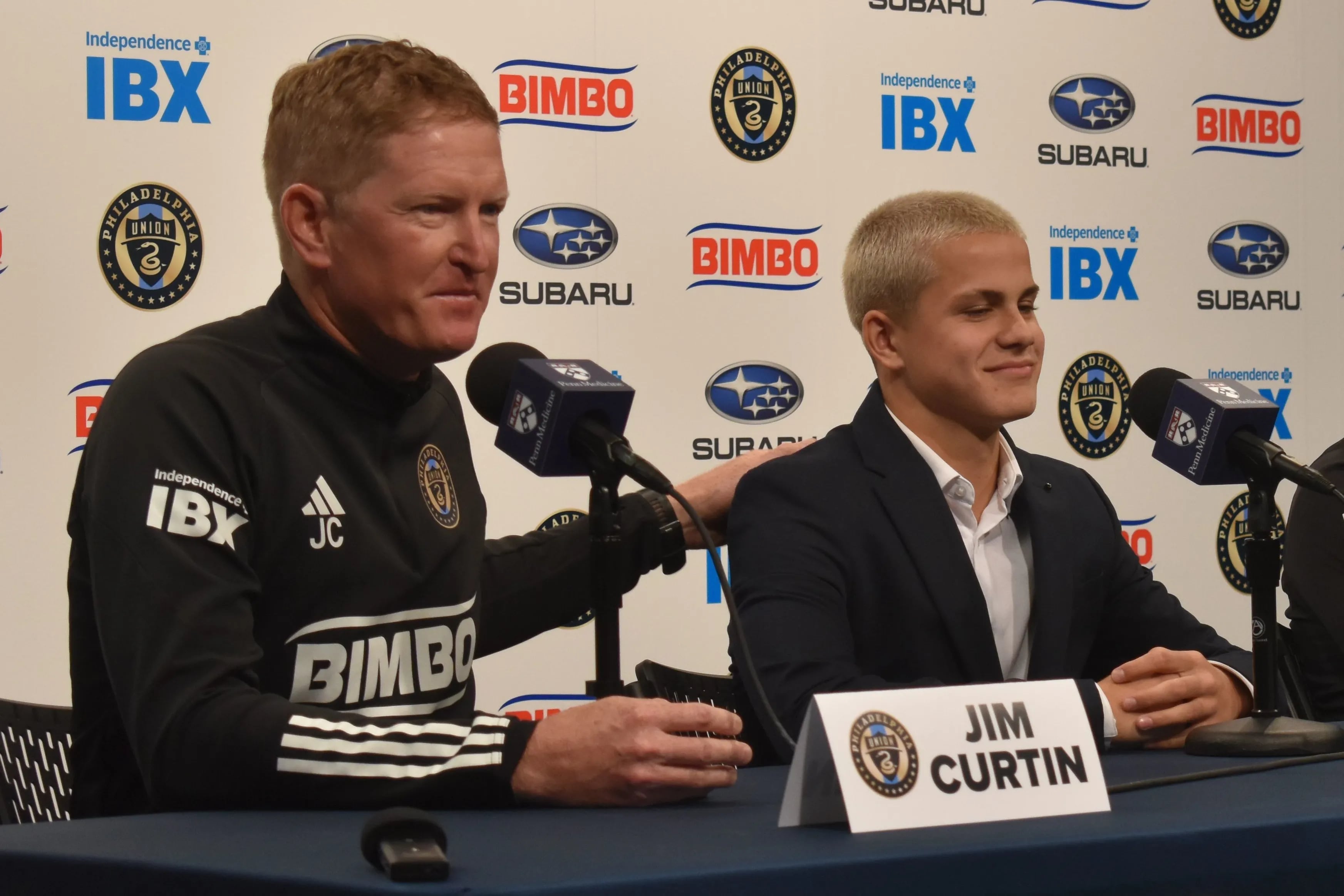 Union manager Jim Curtin (left) pats Cavan Sullivan on the back during Thursday's news conference at Subaru Park.