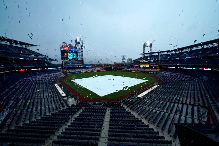 A tarp covers the field at Citizens Bank Park as rain delays the start of a game between the Phillies and Orioles in 2020.
