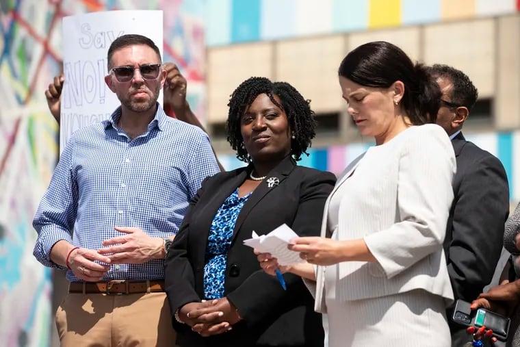 Rep. Ryan Bizzarro (left), House Speaker Joanna McClinton, and Rep. Elizabeth Fiedler stand during a press conference after touring at South Philadelphia High School in Philadelphia in July.