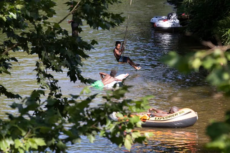 People cool off in the West Branch of the Brandywine River in at the ChesLen Preserve in Newlin Township, Chester County, on July 23, 2022.