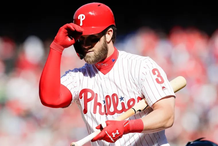 Phillies star Bryce Harper tips his bating helmet during his first-inning at-bat against the Atlanta Braves on Thursday.
