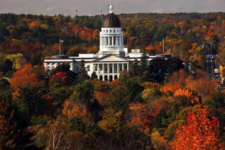 Fall foliage surrounds the statehouse in Augusta, Maine. We’re still waiting.