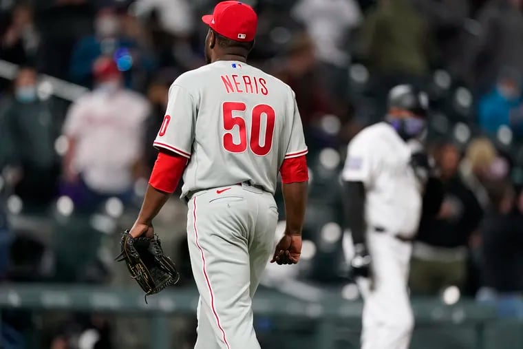 Phillies reliever Hector Neris leaves the mound after giving up a walk-off home run to the Rockies' Raimel Tapia Friday night at Coors Field.