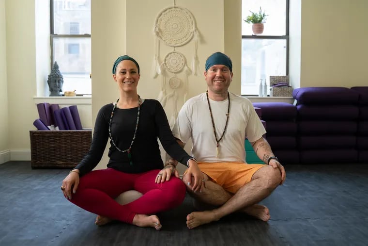 Arielle and Robert Ashford, husband and wife and owners, pose for a portrait in the yoga room at Unity Yoga located on Main Street in Manayunk, Philadelphia on Saturday, August 10, 2019.