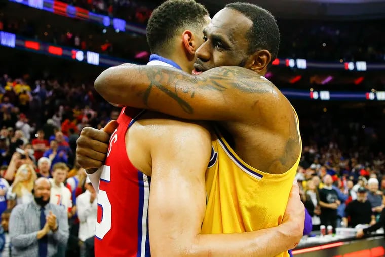 Lakers forward LeBron James and Sixers guard Ben Simmons hug after the Sixers beat the Lakers 108-91 on Saturday.