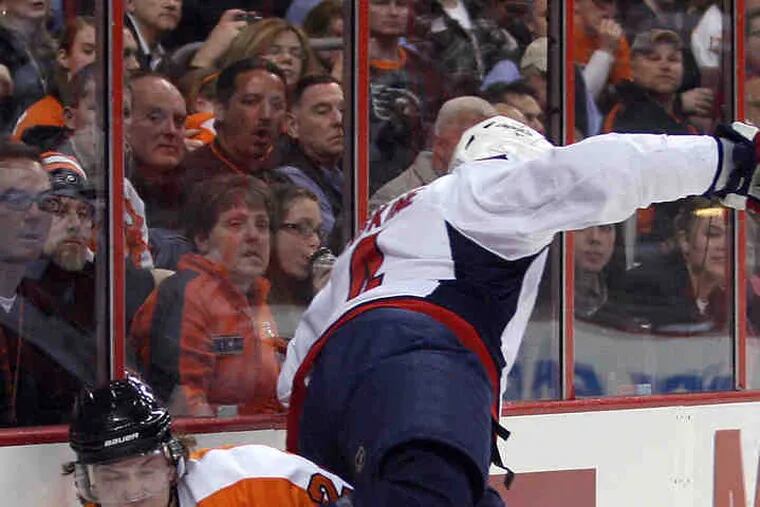 Flyers' Claude Giroux, Capitals' John Erskine meet along the boards in second period.