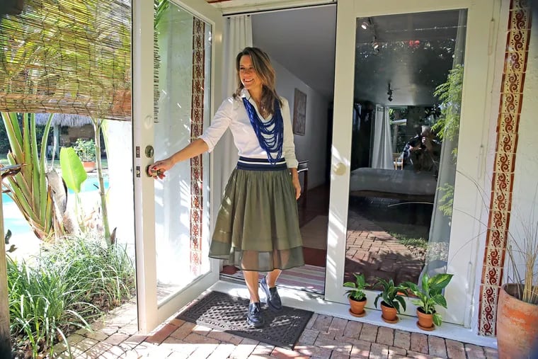 Paola Ugolini stands outside the one-room cottage that is the most popular Airbnb listing in Florida. Her home and the cottage are in the Biscayne Park neighborhood of Miami Shores, Fla.