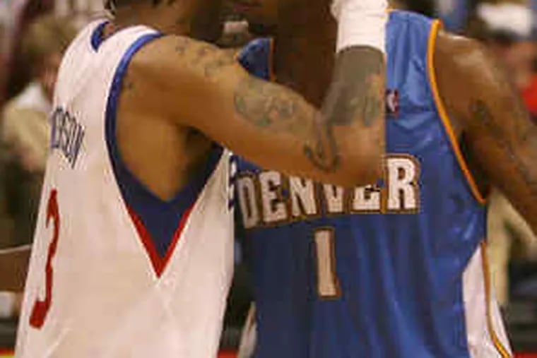 Allen Iverson, Chauncey Billups embrace after Denver defeated Sixers.