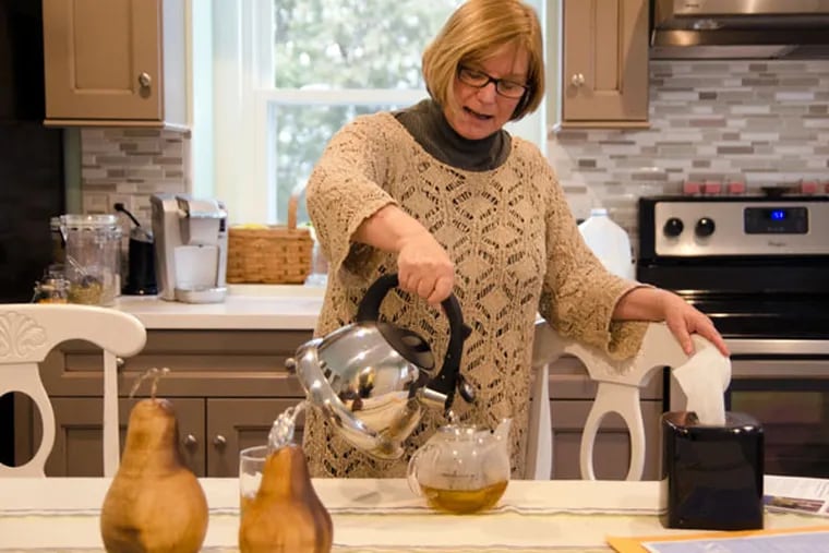 Barbara Bitros pours a cup of tea at her Langhorne home. Bitros, who has been experiencing serious memory loss, says she will end her life before she loses her sense of self. She fears dementia far more than death.