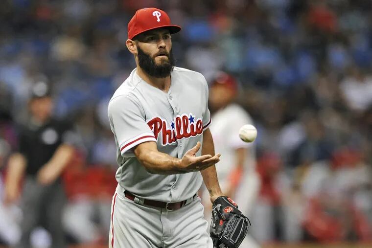 Phillies starting pitcher Jake Arrieta flips the ball to first baseman Carlos Santana after fielding a ground ball during the Phillies’ 9-4 win over the Rays.