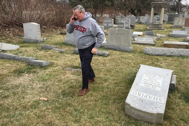 Mayor Jim Kenney surveys the damage at Mount Carmel Cemetery Monday February 27, 2017.