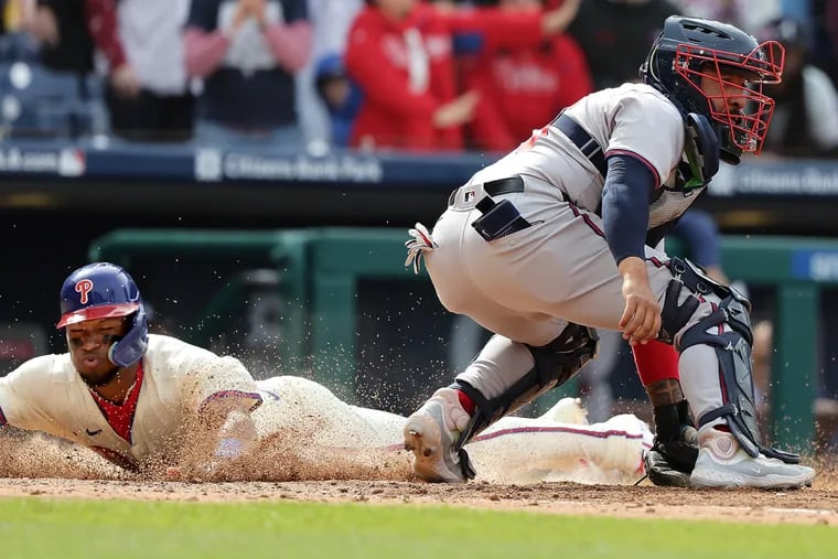 Phillies center fielder Johan Rojas slides safely into home plate during the seventh inning of the victory against the Braves.