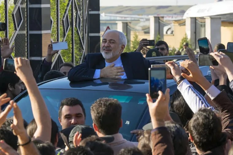 Iranian Foreign Minister Mohammad Javad Zarif, who signed the agreement Thursday, is cheered upon his return to Tehran’s Mehrabad airport from the negotiations in Lausanne, Switzerland. (MORTEZA NIKOUBAZL / Zuma Press / TNS)