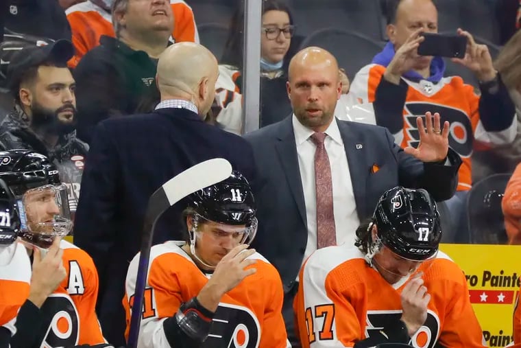 Flyers interim head coach Mike Yeo behind the bench against the Colorado Avalanche during the first period on Monday. Yeo is expected to get the remainder of the season to prove he should be the coach on a full-time basis.