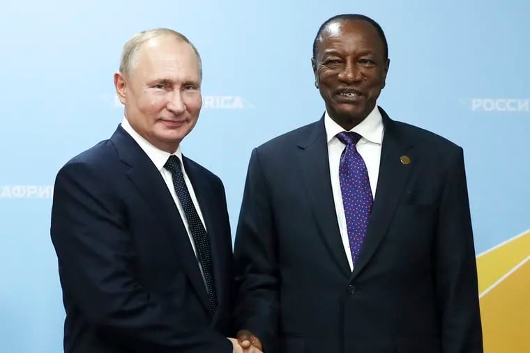 Russian President Vladimir Putin, left, and Guinea's President Alpha Conde pose for a photo during their meeting on the sideline of the Russia-Africa summit in October.
