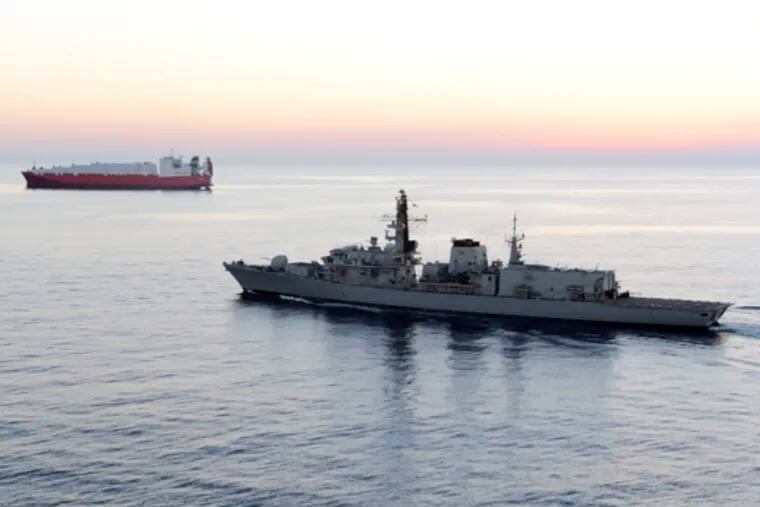 In this image from file video provided by UK Ministry of Defence, British navy vessel HMS Montrose escorts another ship during a mission to remove chemical weapons from Syria at sea off coast of Cyprus in February 2014.  (UK Ministry of Defence via AP)
