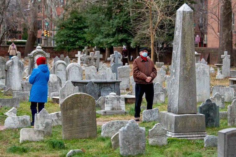 In January 2021, St. Peter's Episcopal Church in Society Hill rang its bell 400 times to mark 400,000 deaths in the nation — a number that's increased by hundreds of thousands since. Vic Compher, right, and Cherlene Compher were among those who stood in the churchyard as the bell tolled.