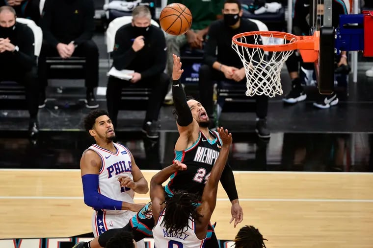 Memphis Grizzlies guard Dillon Brooks (24) shoots between Philadelphia 76ers forward Tobias Harris (left) and guard Tyrese Maxey (0) during the first half of an NBA basketball game Saturday, Jan. 16, 2021, in Memphis, Tenn.