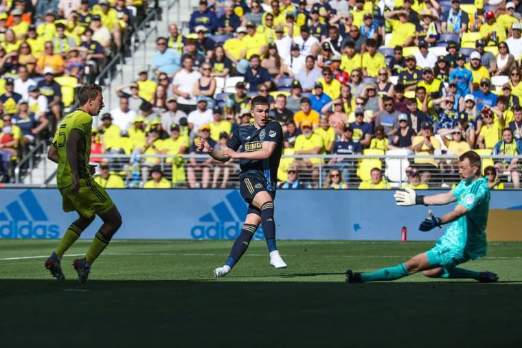 Mikael Uhre (center) shoots past Nashville SC goalkeeper Joe Willis (right) to score his first Philadelphia Union goal in a Major League Soccer game at GEODIS Park in Nashville, Tennessee on May 1, 2022.