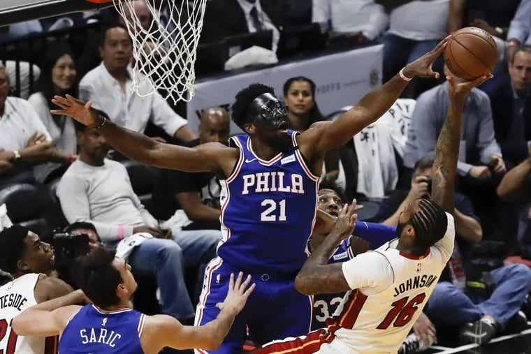 Sixers center Joel Embiid blocks Heat forward James Johnson’s shot during the Sixers’ Game 3 win against Miami on Thursday.
