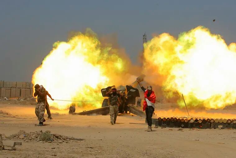In this May 29, 2016 file photo, Iraqi security forces and allied Popular Mobilization forces fire artillery during fight against Islamic State militants in Fallujah, Iraq. When U.S. Secretary of State Mike Pompeo sat down with Iraqi officials in Baghdad earlier this month as tensions were mounting between the U.S. and Iran, he delivered a nuanced message: If you're not going to stand with us, stand aside.
