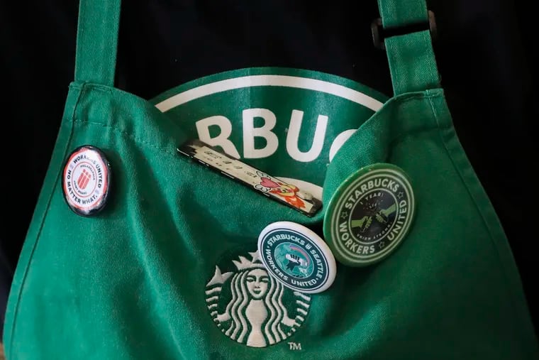 Union pins on a worker's apron at the Starbucks at 901 Market St. in Philadelphia in February.