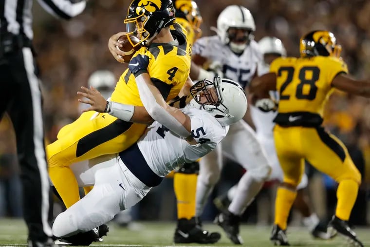 Penn State defensive tackle Robert Windsor (center) sacks Iowa quarterback Nate Stanley.