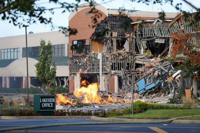 This photo provided by the Howard County Fire And Rescue shows the scene of a damaged building and burning debris nearby after an explosion at an office complex and shopping center in Columbia, Maryland.