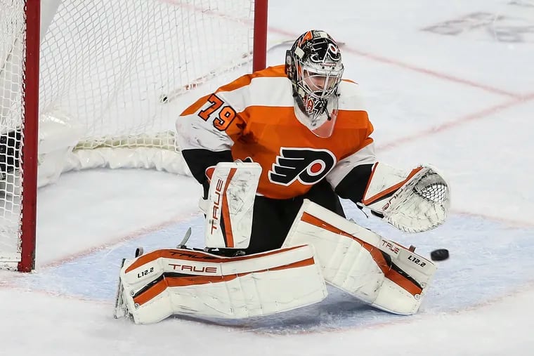 Flyers goalie Carter Hart, working without a stick, deflects a shot against the Golden Knights during the second  period.