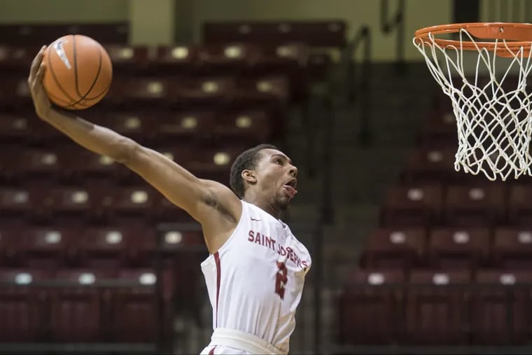 St. Joseph’s sophomore Charlie Brown doing a windmill dunk last week at Hagan Arena.