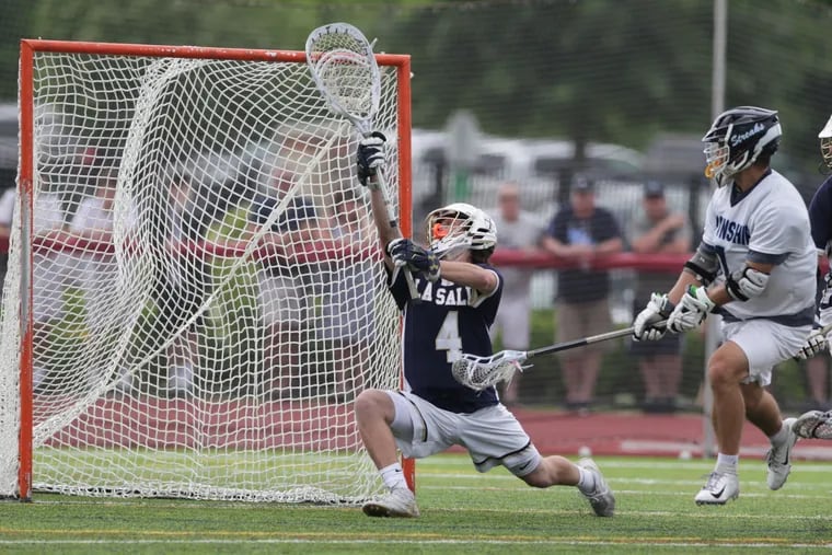 Grayson Sallade, right, of Manheim Township celebrate scores against Michael Clibanof of La Salle to give Manheim Township a 6-4 lead in the 4th quarter against in the PIAA Class 3A State Boys' Lacrosse Championship game at West Chester East High School on June 9, 2018.