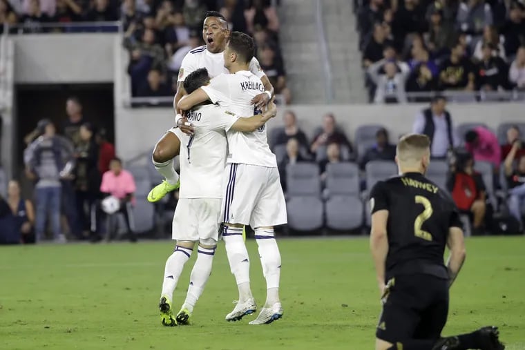Real Salt Lake's Jefferson Savarino, Joao Plata (top) and Damir Kreilach celebrate after an own goal by Los Angeles FC gave RSL the lead during the second half.
