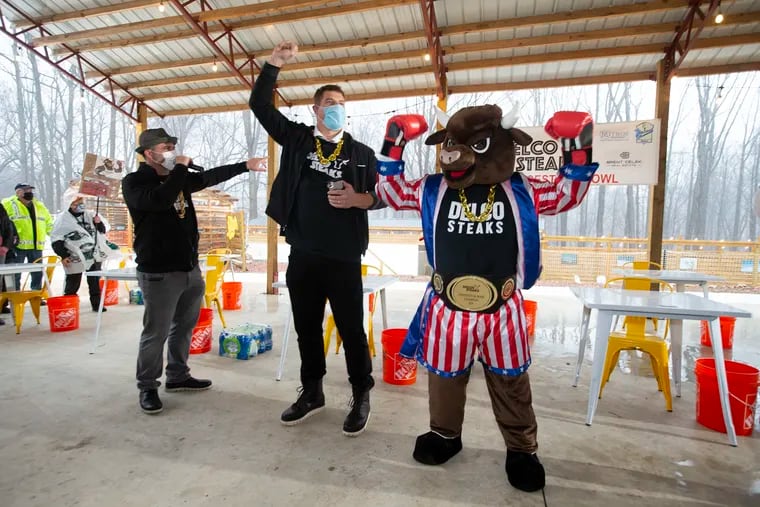 Former Eagle Brent Celek (center) and the Delco Steak mascot  at the start of the event
 Delco Steaks of Broomall, PA, celebrates National Cheesesteak Day On March 24, 2021 with the Cheesesteak Bowl at Splash Swim Club. Over 50 contestants will try to devour the Delco, a two-foot cheesesteak featuring 1.5-pounds of meat, faster than their opponents. Delco Steaks will award a championship belt and an all-expenses paid trip to Cancun to the winner and will donate a portion of the proceeds from National Cheesesteak Day to Coaches vs. Cancer.